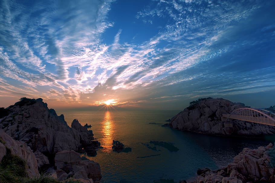 photo of bridge near mountain and sea at golden hour, ulsan, sunrise