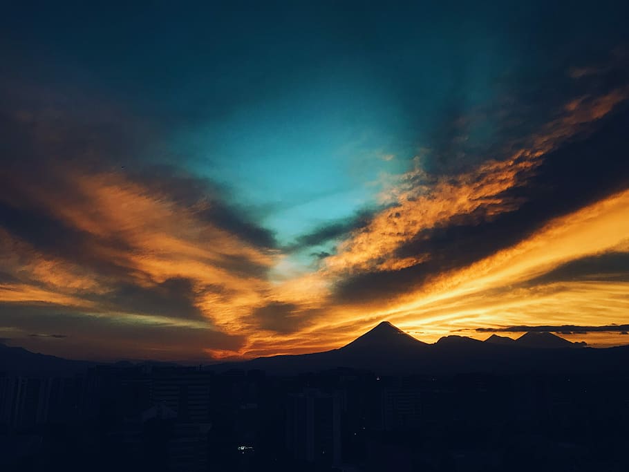 mountain during sun set, landscape photography of silhouette of mountains under blue and orange sky HD wallpaper