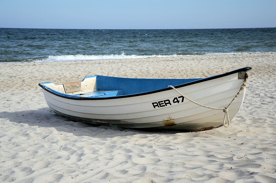 Boat Docked On The Sand At The Ocean Stock Photo - Download Image
