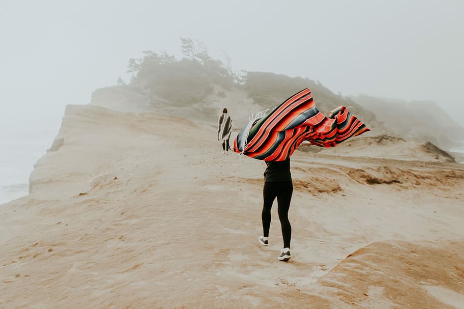 person carrying shawl, person covered with orange and black striped textile HD wallpaper