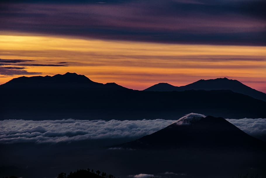 silhouette of mountain during sunset, landscape photography of mountains under yellow sky HD wallpaper