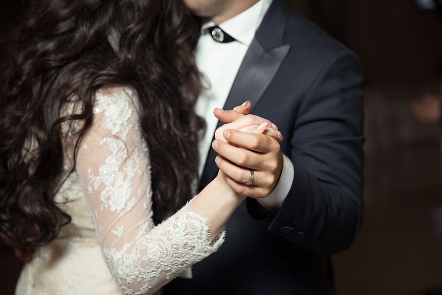 man wearing black peak lapel suit jacket and woman wearing white lace long-sleeved dress holding hands while dancing, HD wallpaper