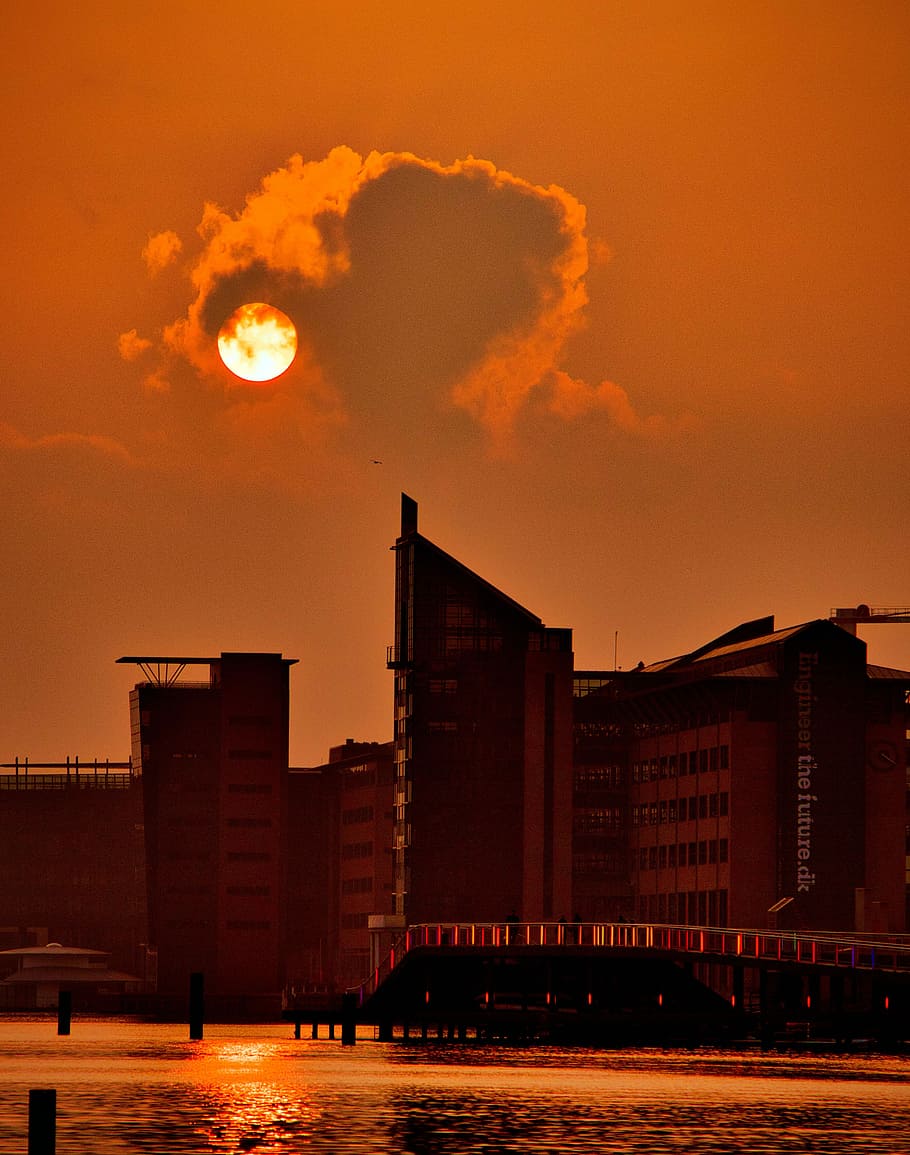 Eternal Sunset Art Installation, black and red concrete high-rise building near body of water at golden hour HD wallpaper