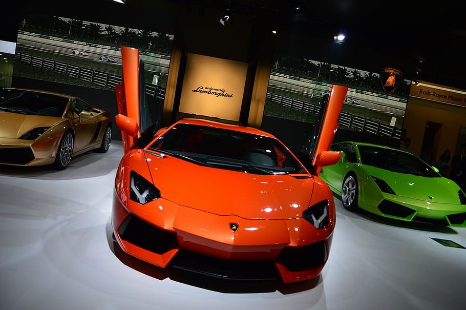 three orange, yellow, and green Lamborghini Aventador coupes parked on pavement, HD wallpaper