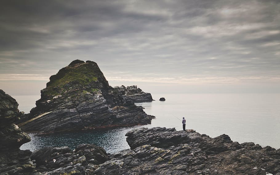 person fishing standing on rock, rocks, oceans, seas, waves, fishing rod