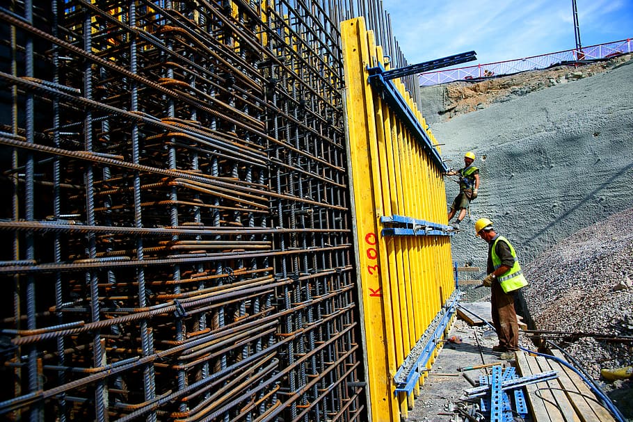 man standing in front of metal wall, industry, construction, worker
