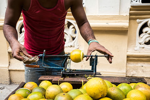 Peeling yellow oranges the Cuban way, fruit, hands, outside, process HD wallpaper