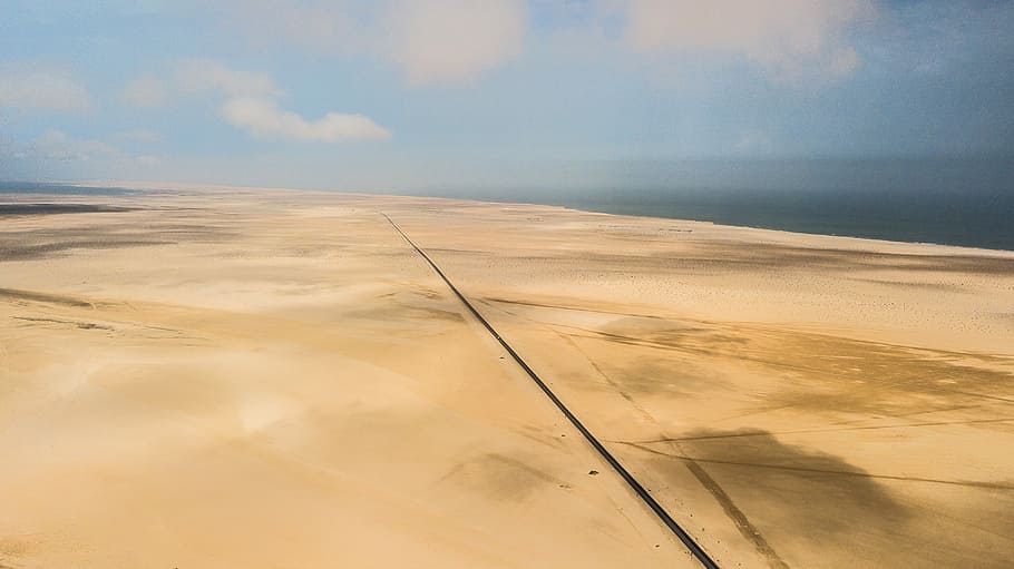aerial view of dessert, brown desert under gray clouds at daytime HD wallpaper