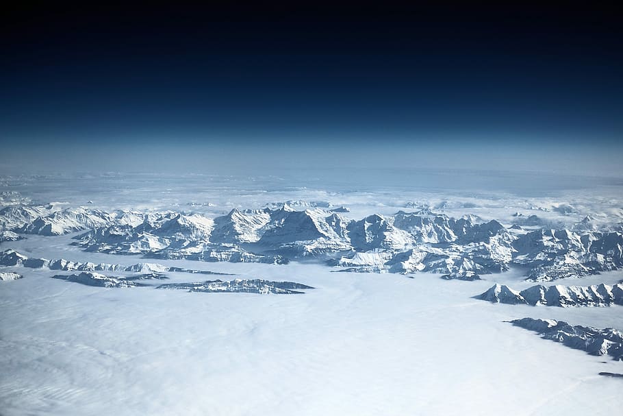 aerial view photography of white snow-covered mountain, aerial photography of snow cap mountains near bodies of water at daytime HD wallpaper