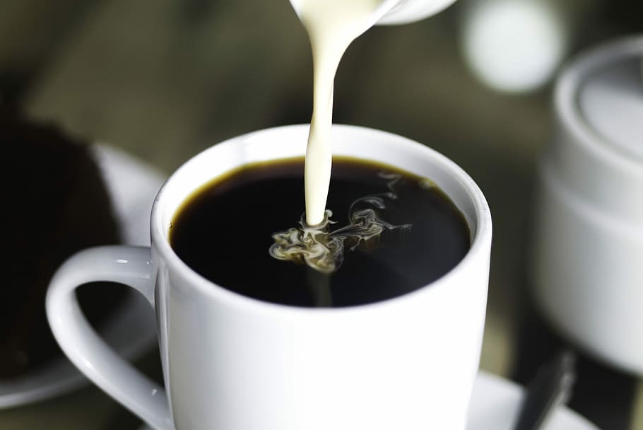 coffee in white ceramic mug while pouring milk, ceramic cup filled with coffee and creamer HD wallpaper