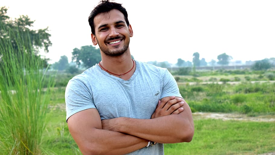 man standing on grass and smiling, head, pose, smile, style HD wallpaper