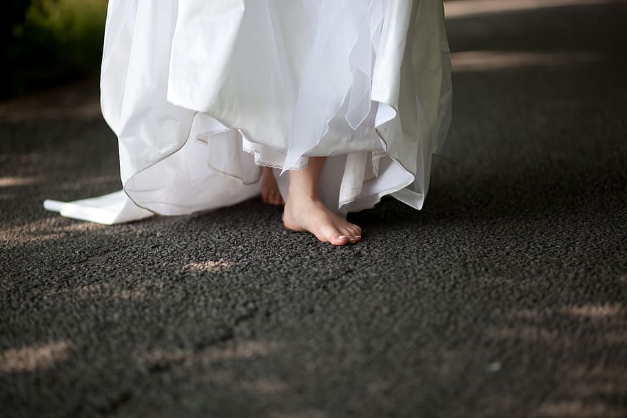 woman wearing white dress walking on black area rug, bride, road