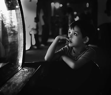 grayscale photo of boy leaning on wooden desk, thinking, pensive HD wallpaper