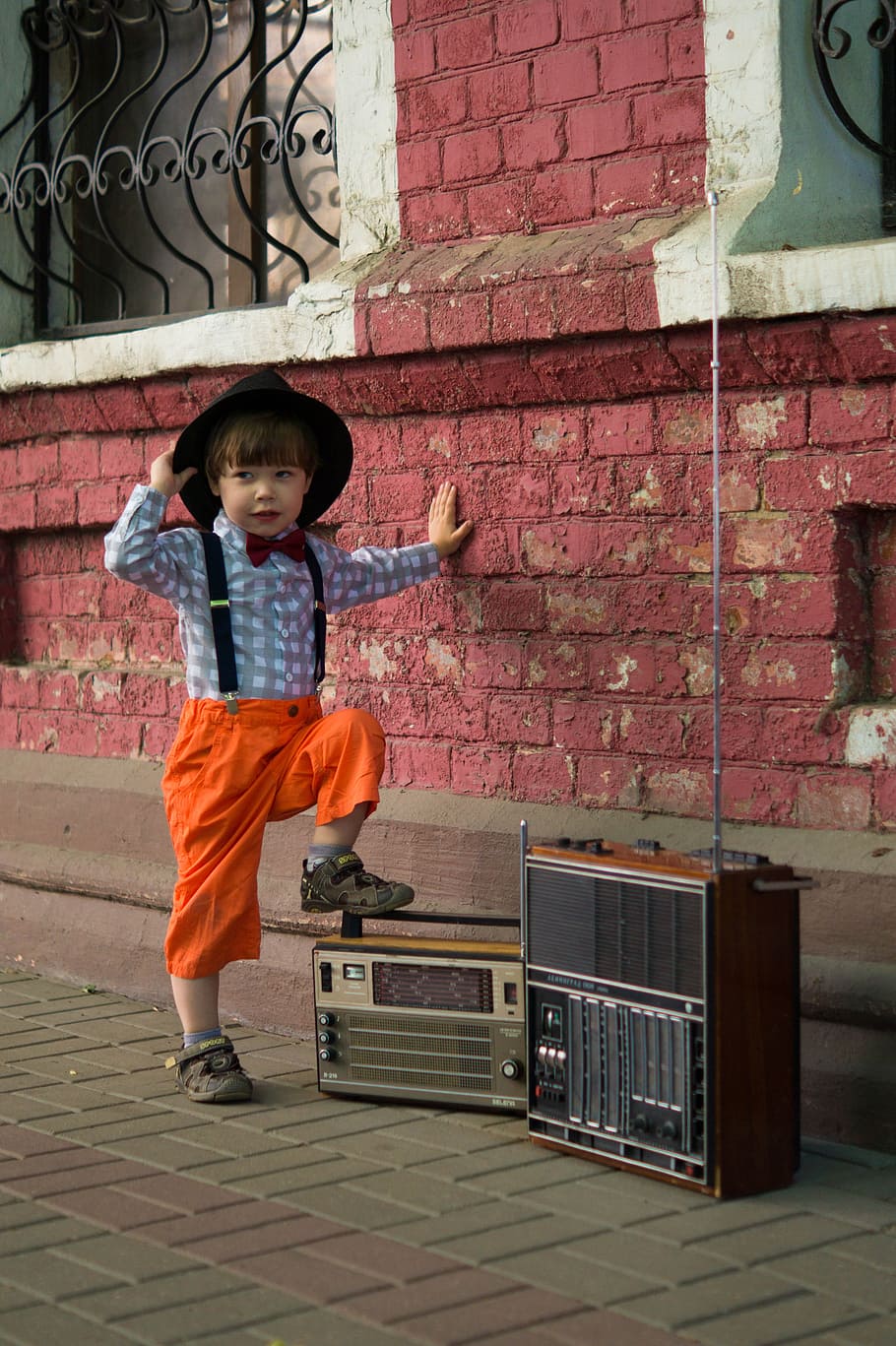 boy standing beside two vintage radios, retro, hat, kids, classic