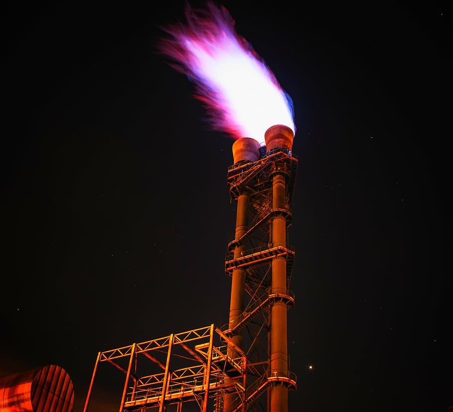 low-angle photography of lighted power plant, fire, flame, torch