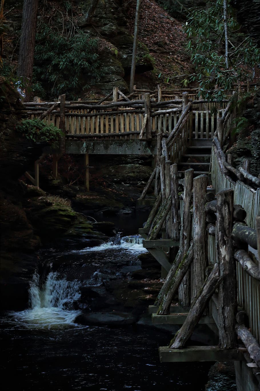 brown wooden foot bridge, brown wooden bridge above river near green trees landscape photography HD wallpaper