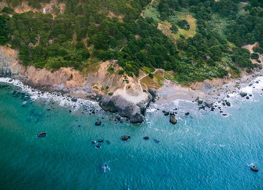 aerial photo of island surrounded by water taken at daytime, island with rocky shore HD wallpaper