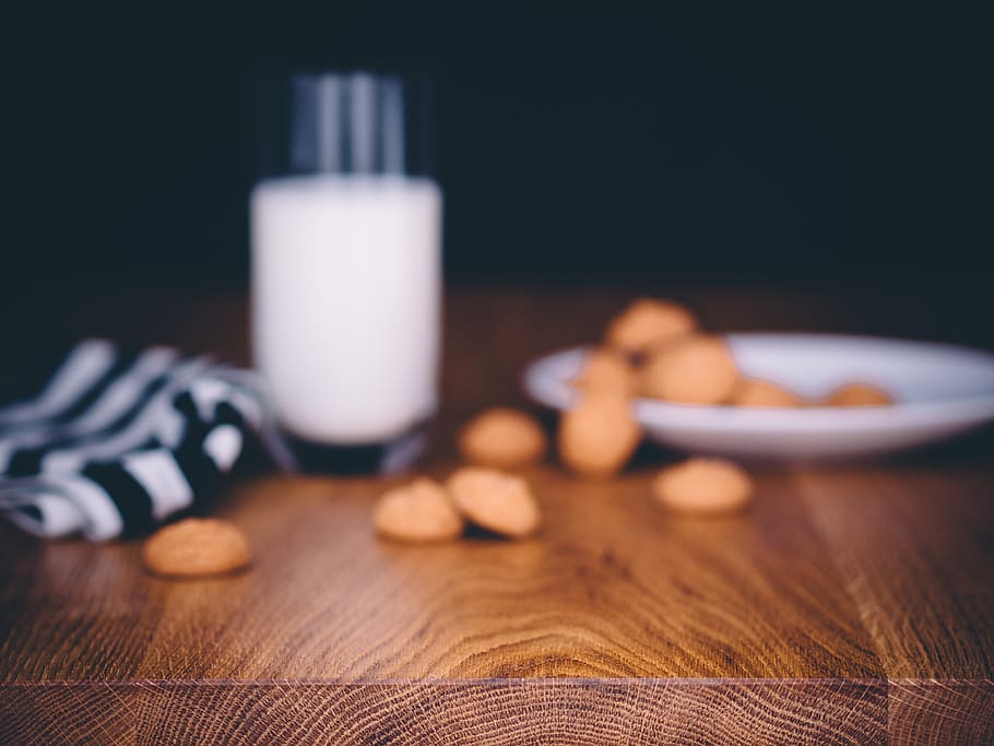 several cookies on round white plate beside glass full of milk HD wallpaper