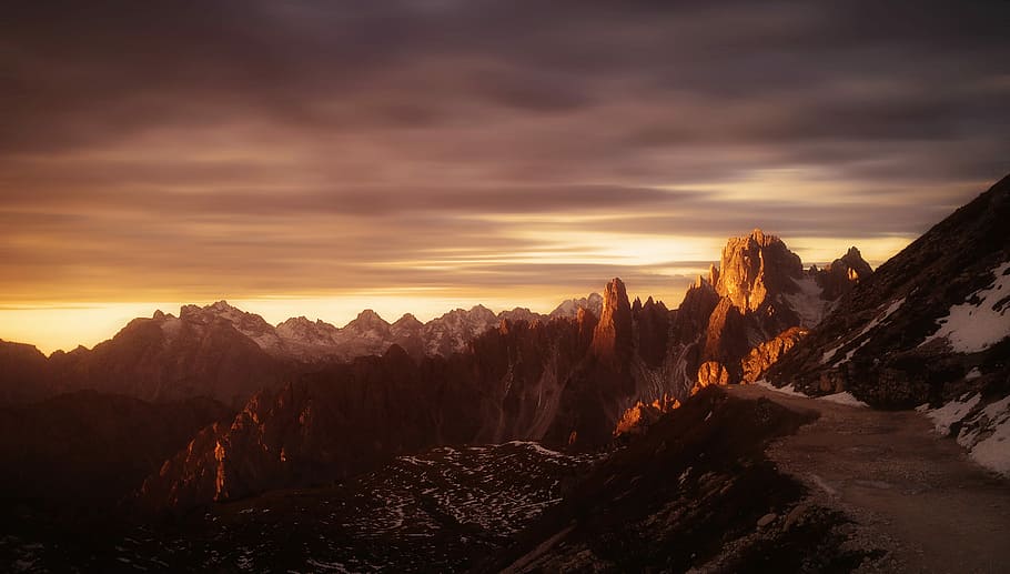 landscape photo of mountain range during golden hour, aerial photo of snow covered mountain during sun rise HD wallpaper