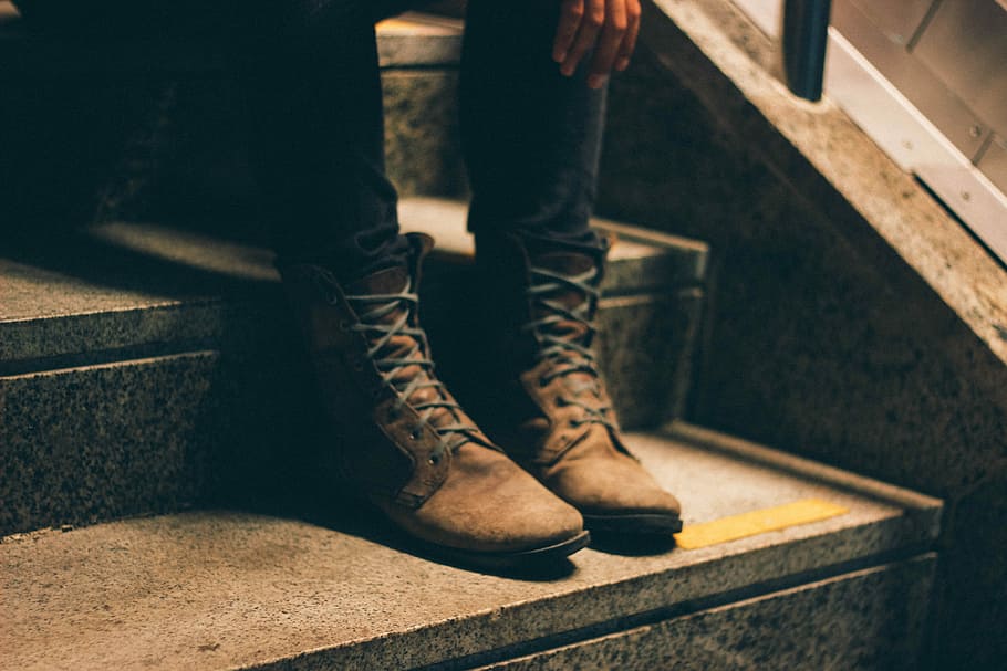 person wearing pair of brown lace-up boots with sitting on stairs, person wearing black pants and brown boots HD wallpaper