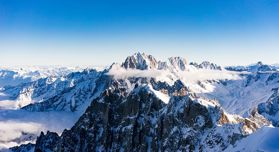 aerial photography of snow covered mountain, snowy mountain under blue sky at daytime HD wallpaper