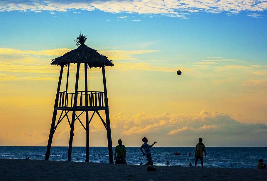 person playing ball on beach near watch tower, sunset, da nang HD wallpaper