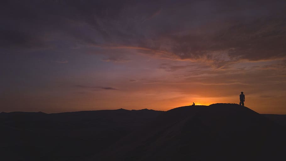 silhouette of person standing on hill during golden hour, silhouette of man standing on hill during sunset HD wallpaper