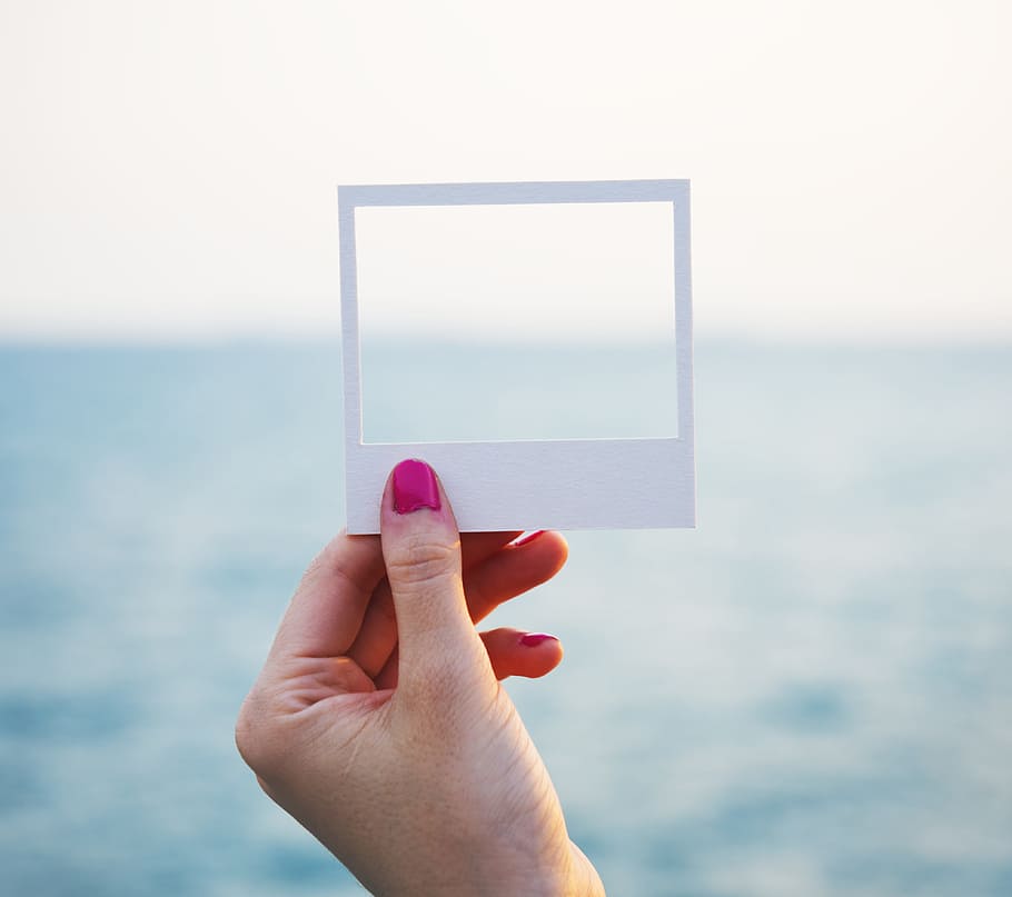 person's hand holding white square paper frame, shore, craft, HD wallpaper