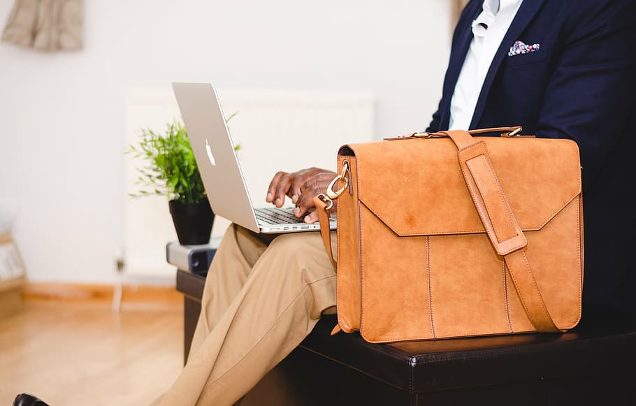person holding silver MacBook, bag, chair, computer, indoors HD wallpaper