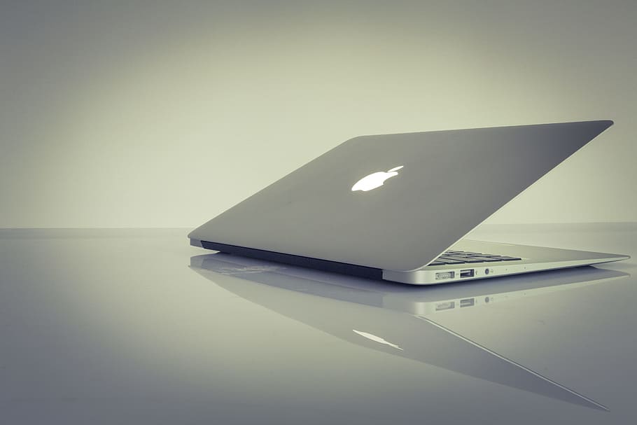 MacBook Air on top of white table, silver MacBook Air on gray surface HD wallpaper