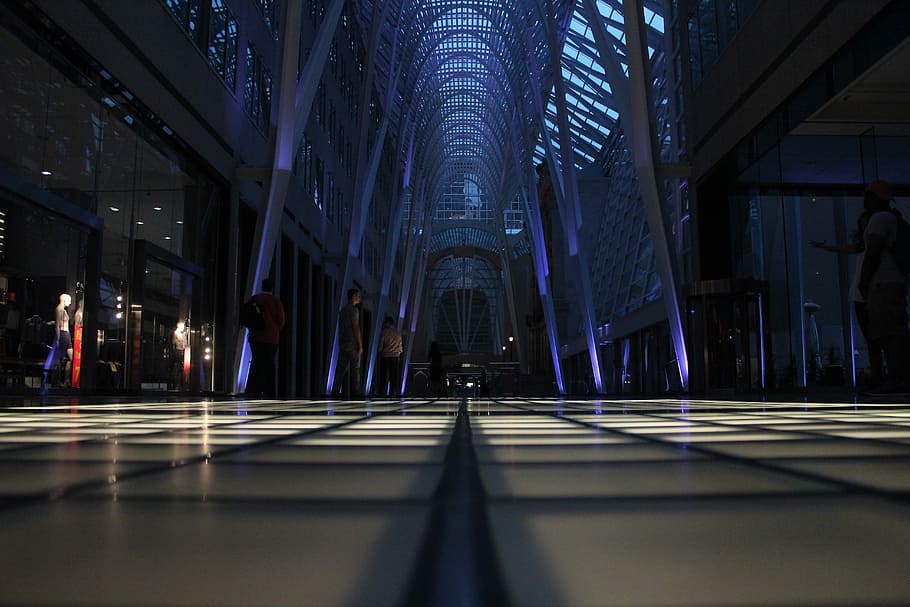 crowd of people inside triangular building interior, people standing inside building HD wallpaper