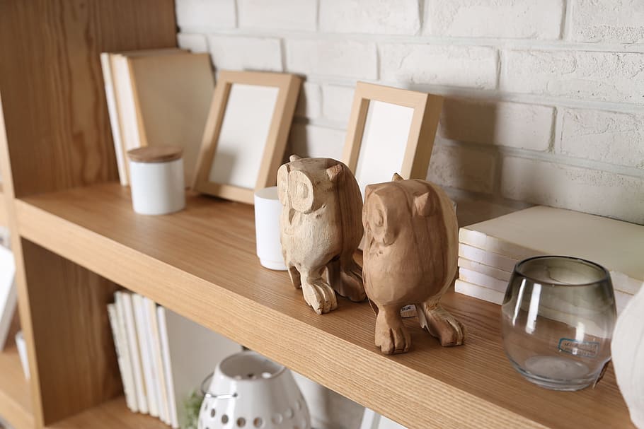 brown bird figurines near photo frames on wooden shelf, bookcase HD wallpaper