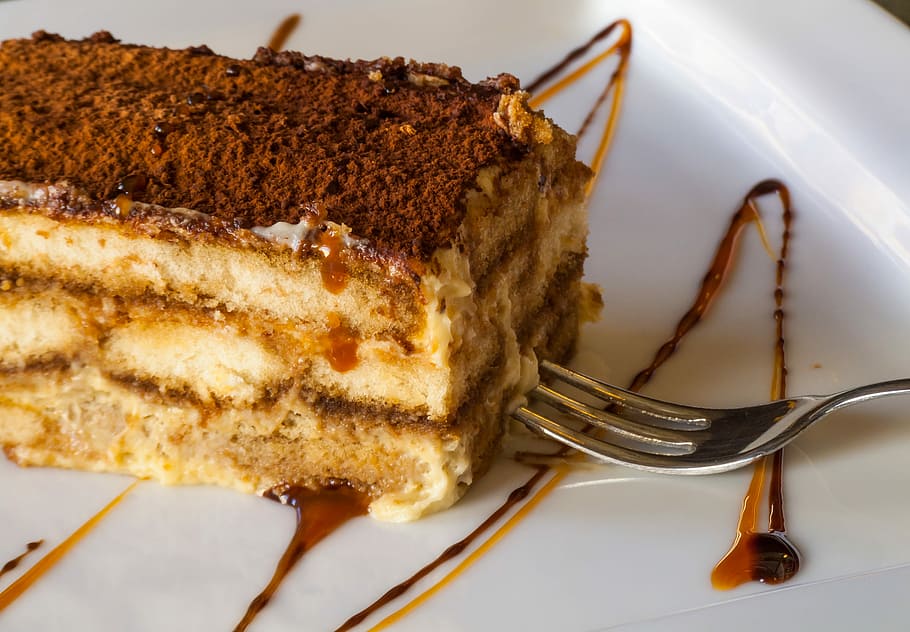 traditional rich tiramisu cake with cinnamon, slice of cake served on white ceramic plate HD wallpaper