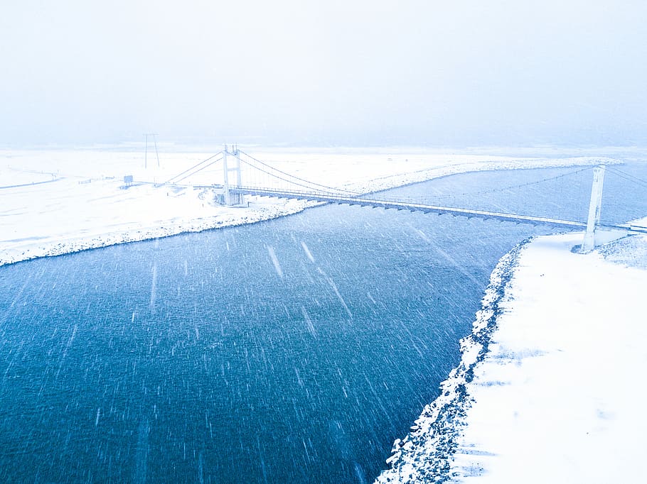 aerial view of bridge coat snow over body of water, photo of cable bridge over body of water during daytime HD wallpaper