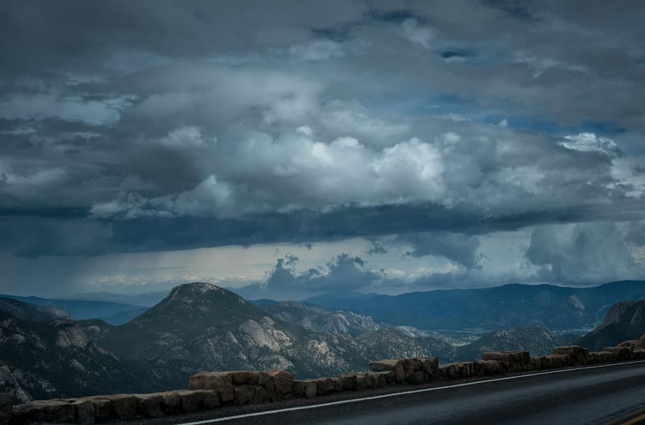 gray rocky mountains under cloudy sky during daytime, grey concrete road and mountains HD wallpaper