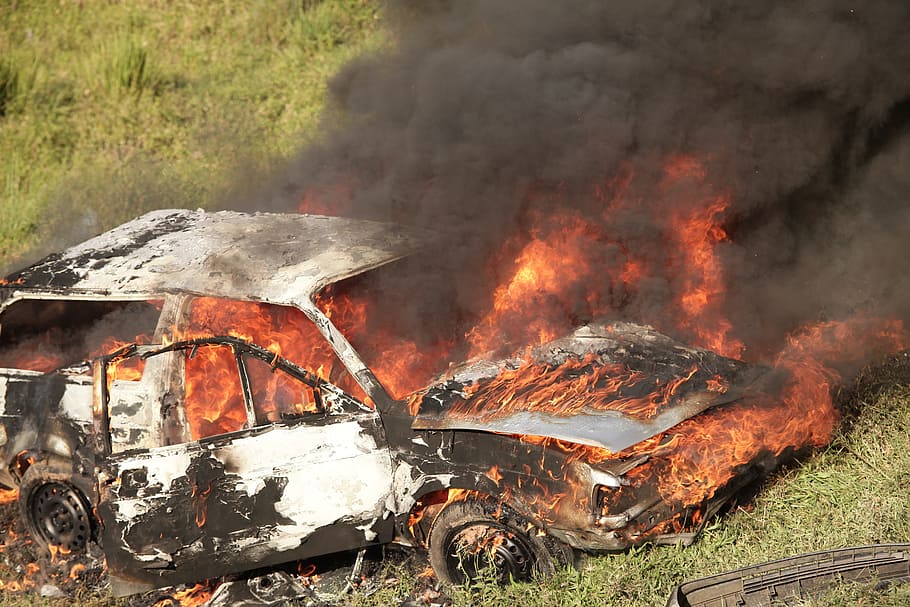 white car under fire on green grass during daytime, burning HD wallpaper