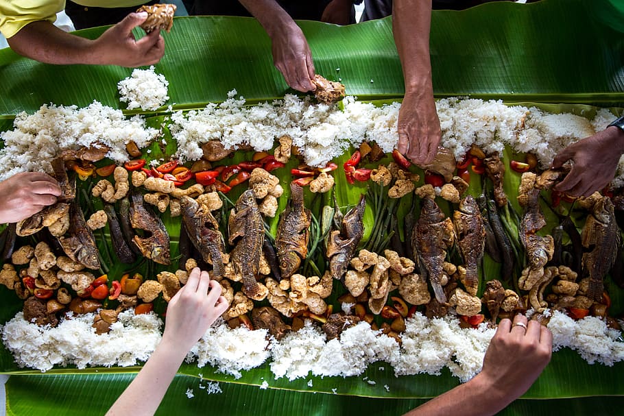 photo of people eating rice, people having boodle fight, meal