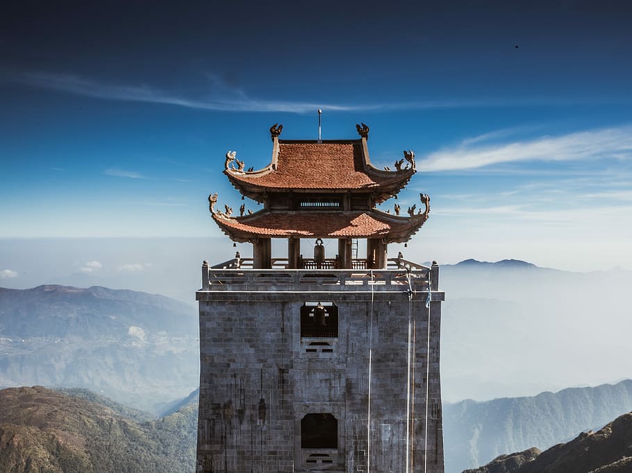 pagoda near mountain at daytime, black and red concrete temple overlooking mountain at daytime HD wallpaper