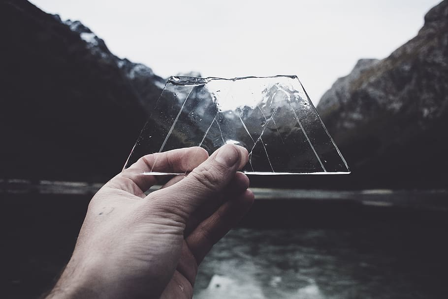 person holding clear glass panel, Ice shapes the mountains., hand HD wallpaper