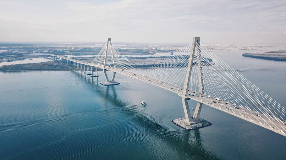 aerial photo of bridge during daytime, suspension bridge with cars during daytime HD wallpaper
