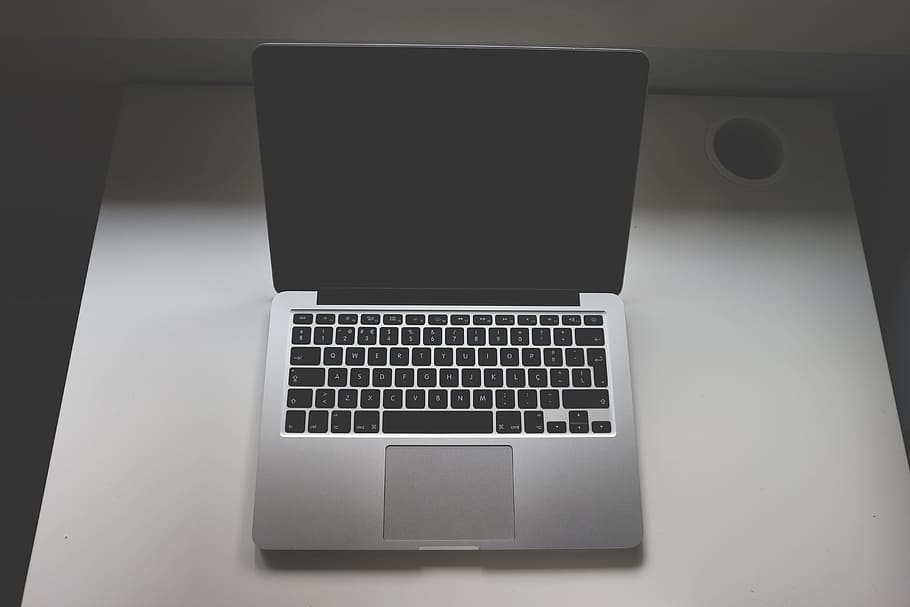 MacBook Pro on table, gray and black laptop computer on white table HD wallpaper