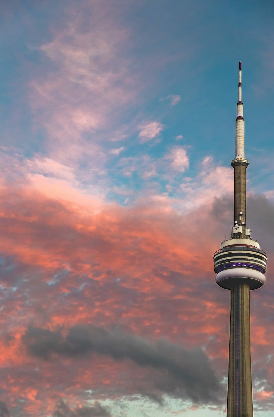 CN Tower under red and gray clouds, low angel photography of CN Tower during golden hour HD wallpaper