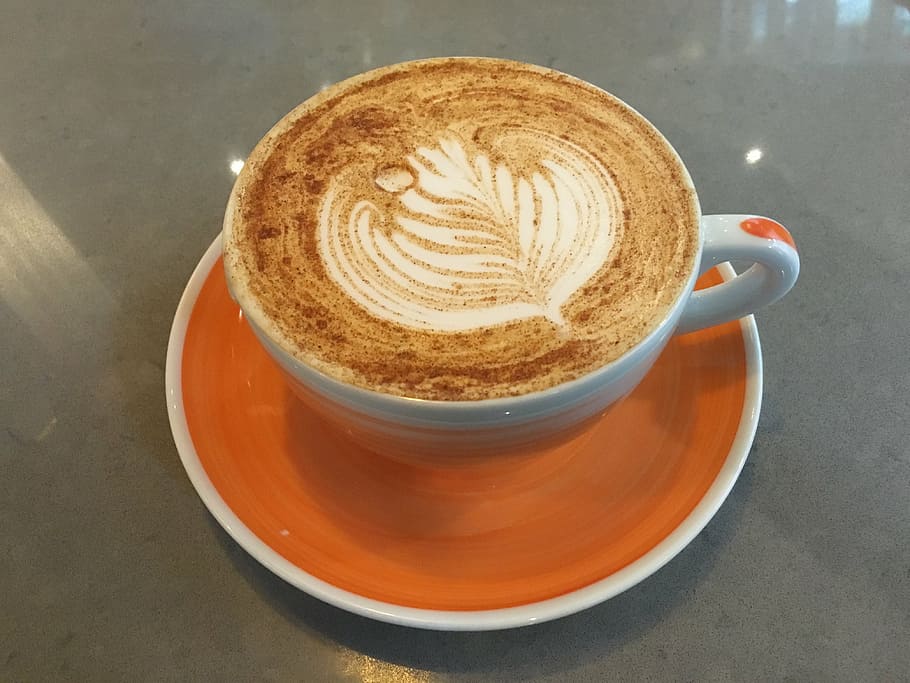 white ceramic cup on orange saucer, chai latte, tea, beverage