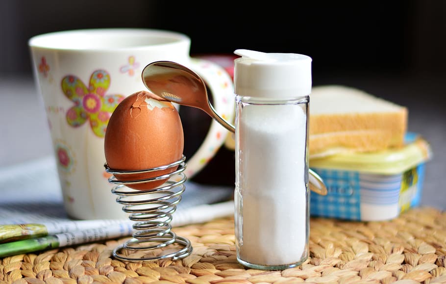 silver spiral egg holder placed beside salt condiment shaker HD wallpaper