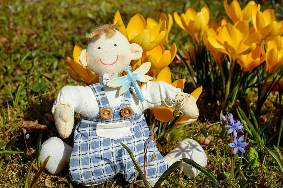 doll with yellow flowers, boy, fabric, sitting, happy, meadow HD wallpaper