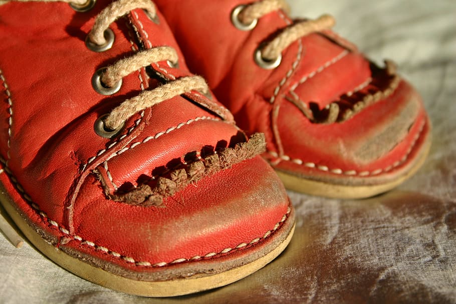pair of red leather shoes on brown surface, children's shoe, baby