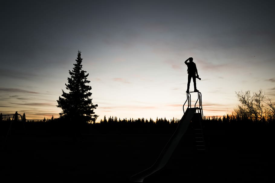 HD wallpaper: silhouette of a person standing on frame near tree during