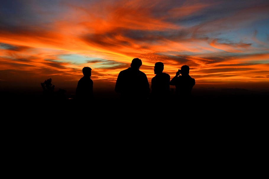 silhouette of four person under orange sky, silhouette of person standing at golden hour HD wallpaper
