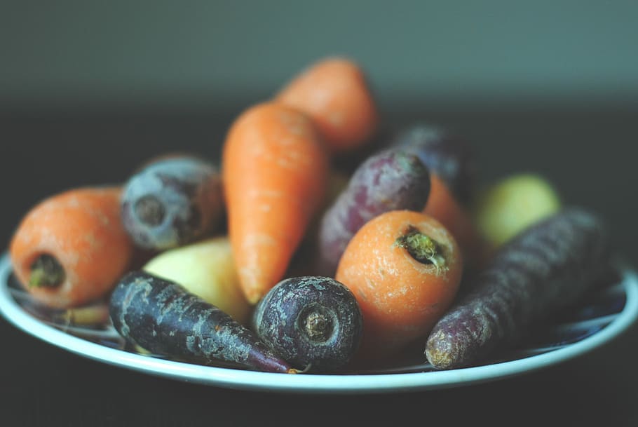 bunch of carrots on white plate, selective-focus photography of carrots on plate HD wallpaper