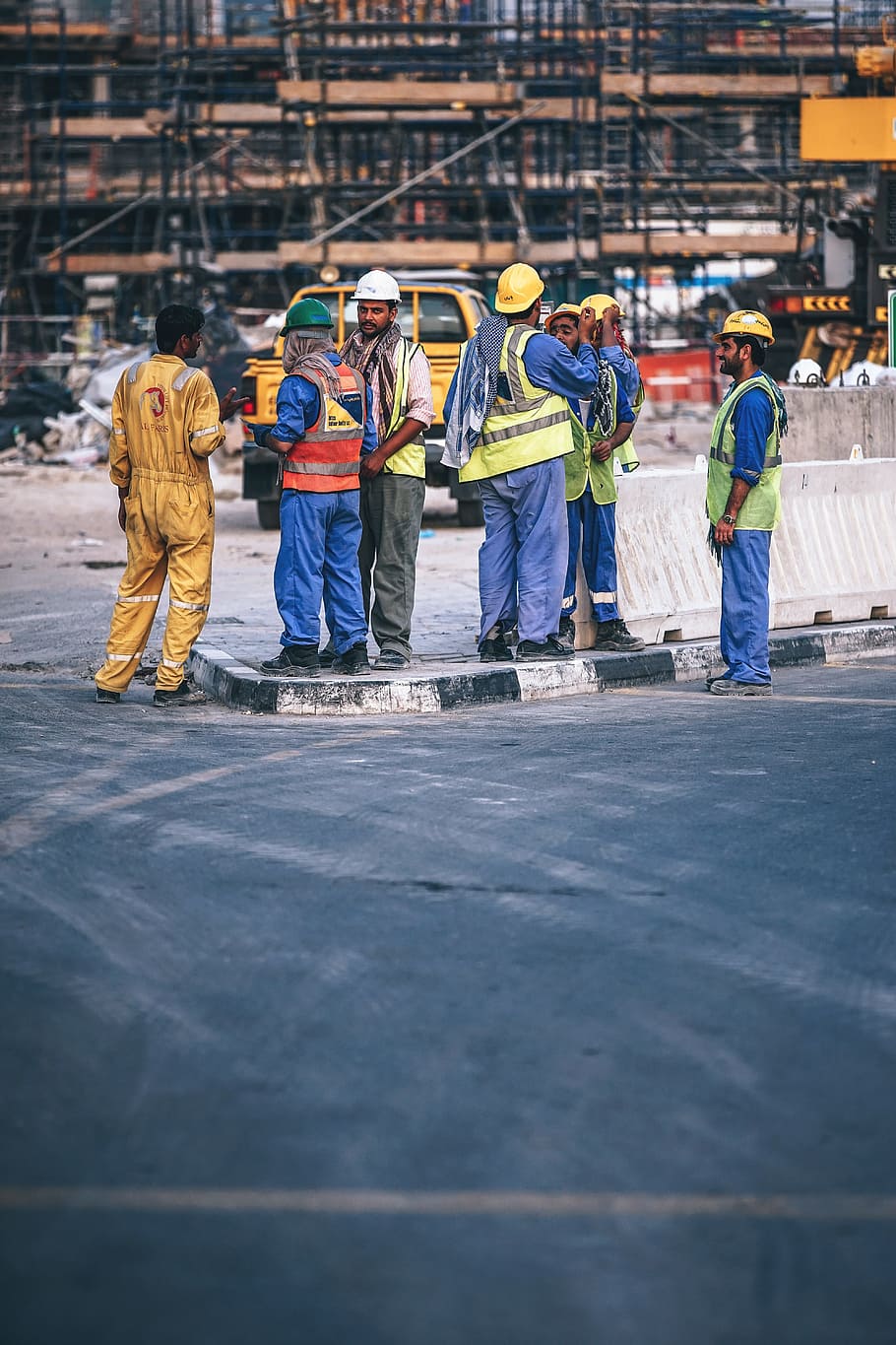 construction workers stands in front of construction site, active